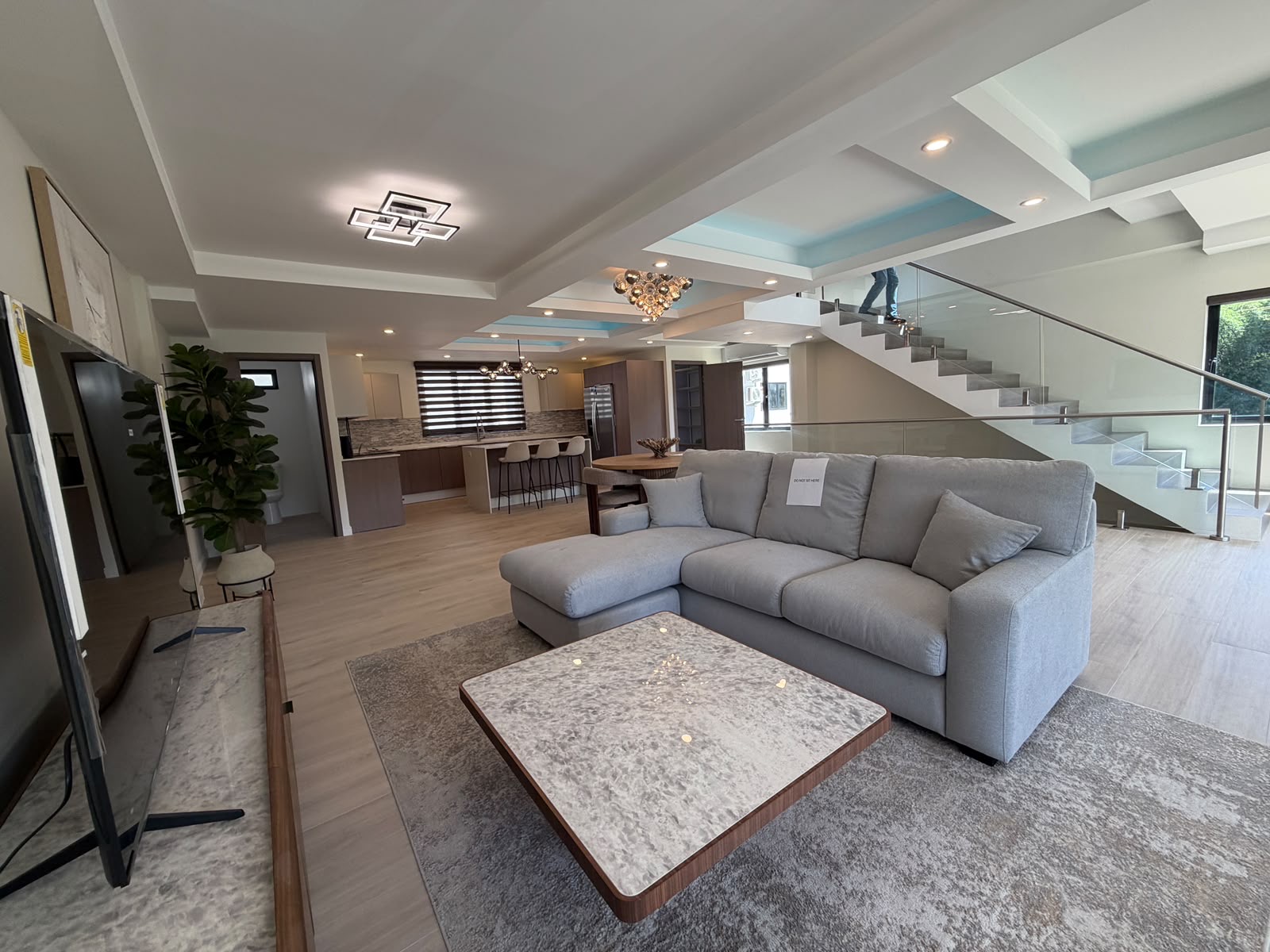 Open-plan living area with floating staircase