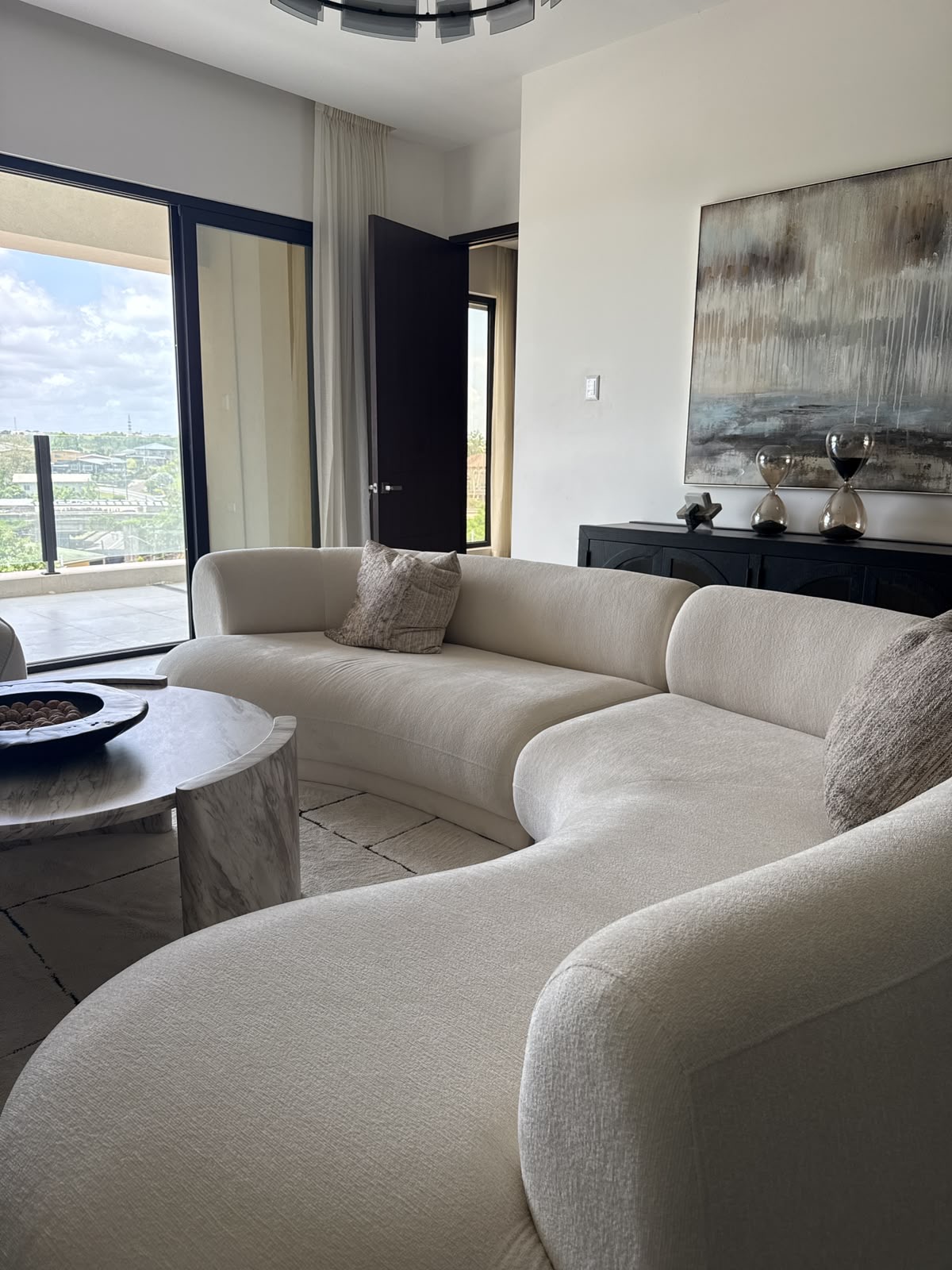 Living room with curved sofa and panoramic windows